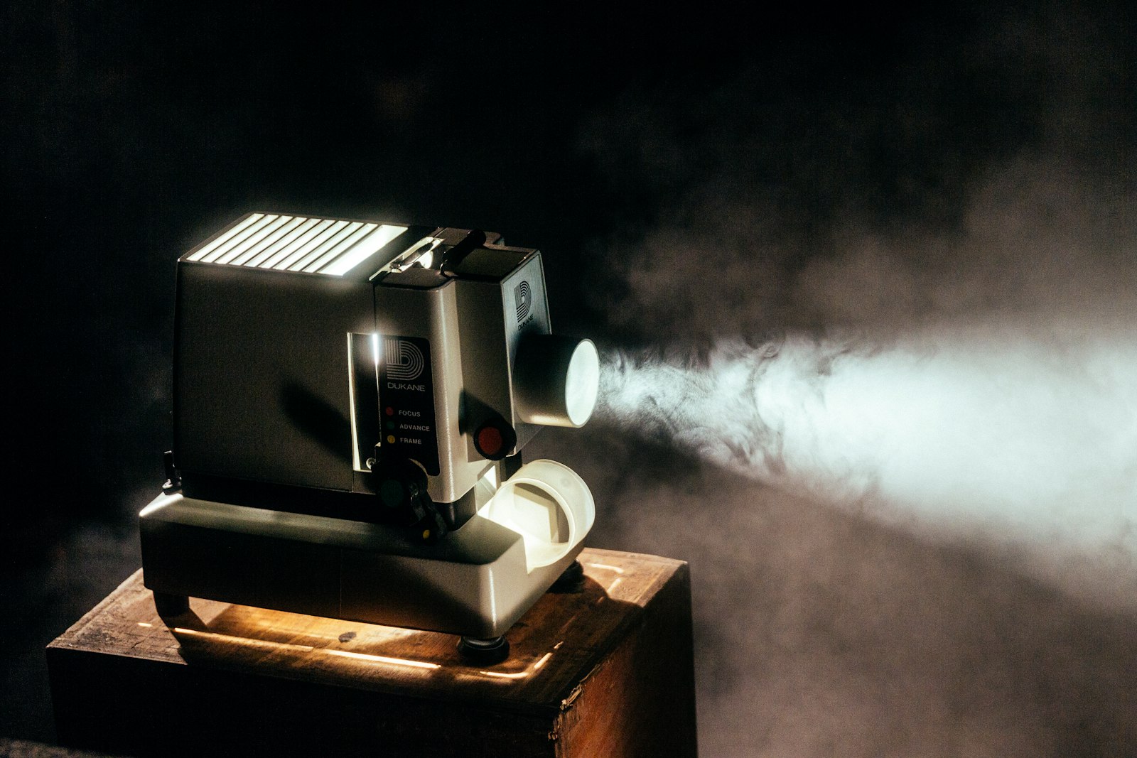 Projector casting a bright beam of light in a dark room