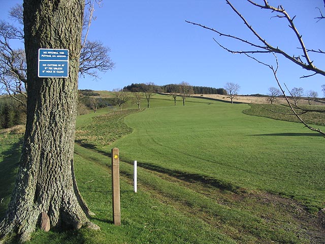 A real golf course fairway lined with trees