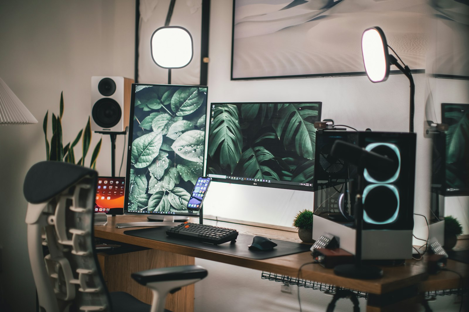 A clean computer monitor and keyboard on a white wooden desk