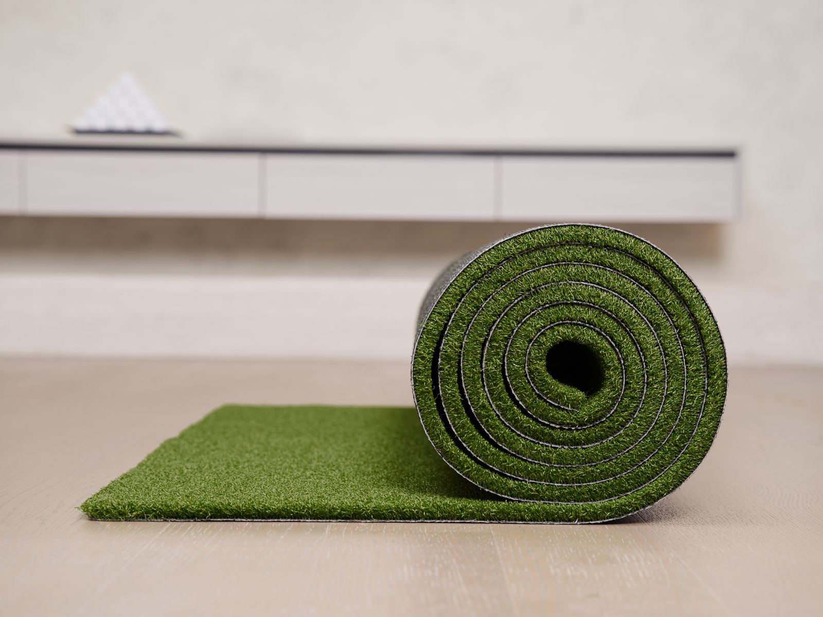 A premium rolled turf golf hitting mat for a home simulator