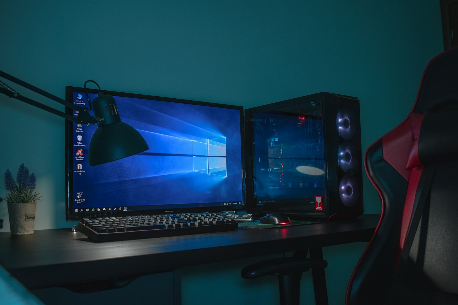 A turned-on desktop computer setup with a gaming chair