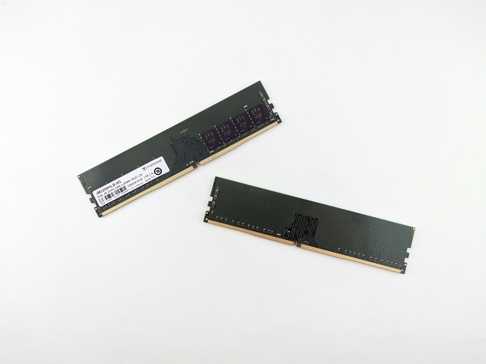 A pair of RAM memory modules on a white surface