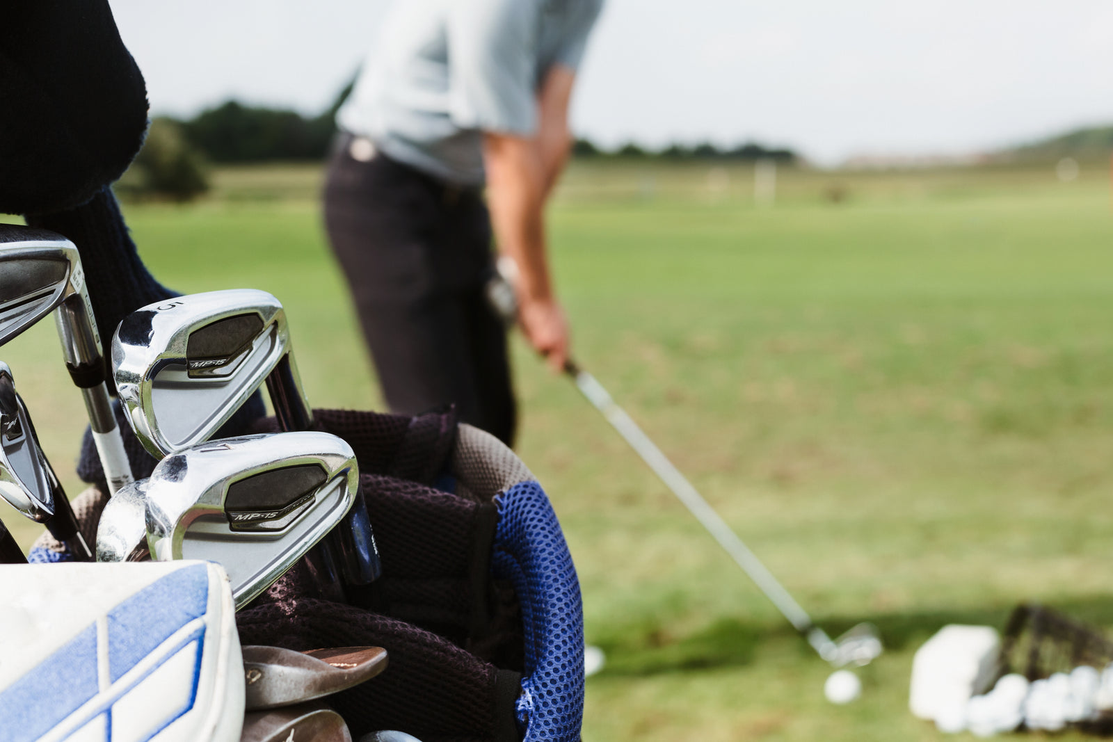 A golfer lining up a shot at a driving range