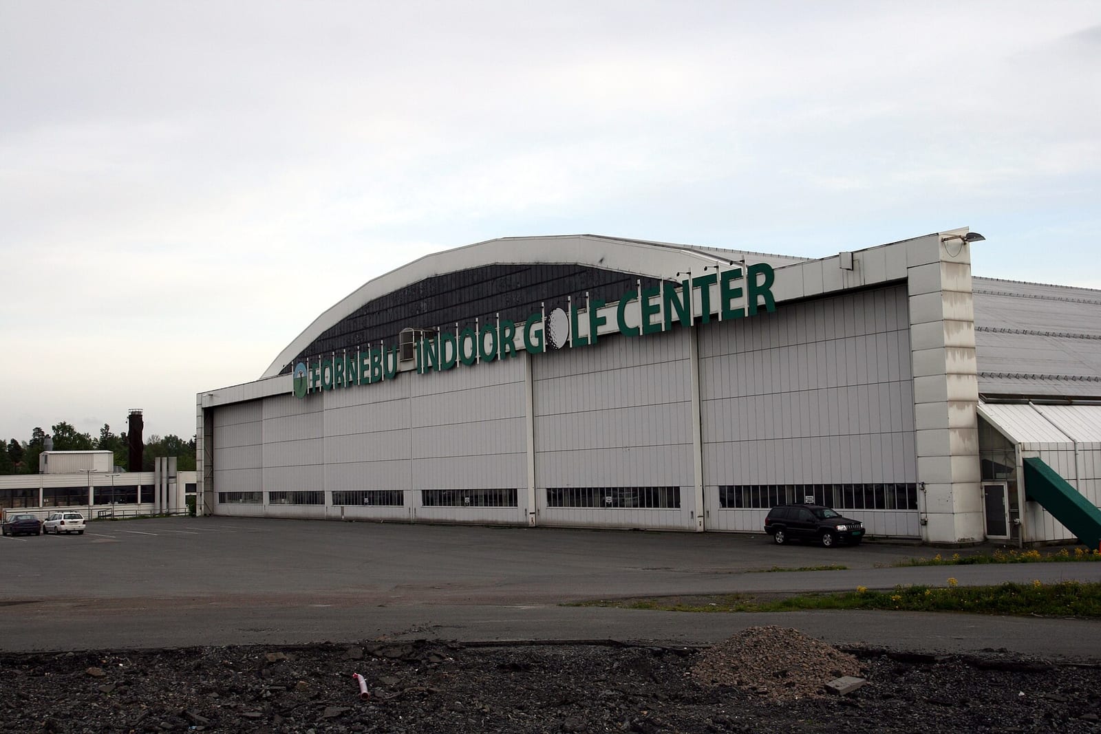 Interior of an indoor golf center with multiple practice bays